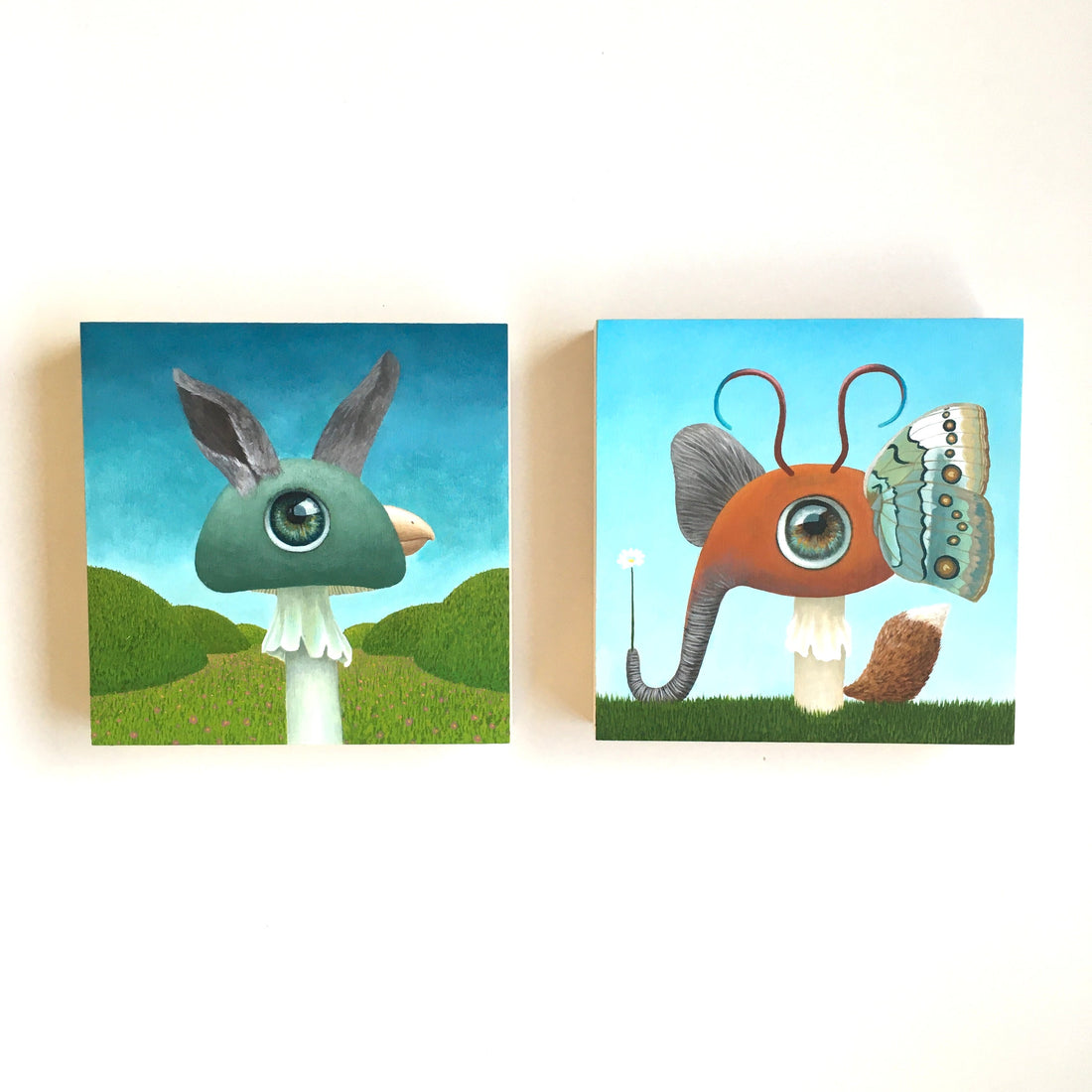 2 Paintings from Meaghan's series "Creatures as Confused as I Am," which combine animals like a bunny and a bird on a mushroom base with a big eye.